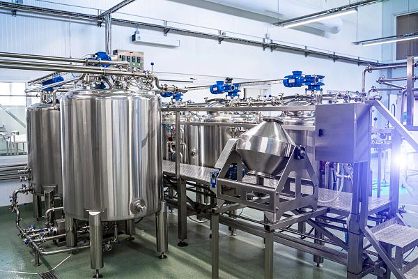 Interior of dairy factory with fermentation tank. Technology equipment at dairy farm. Sterile production.