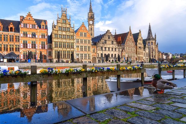 Scenic view of the historical city center of Ghent (Gent), Belgium. Beautiful cityscape with medieval architecture, monumental landmarks and Lys river with tourist boats, outdoor travel background